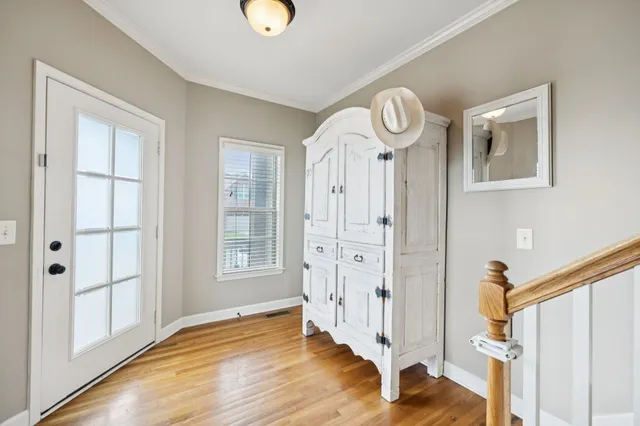 a view of an entryway with wooden floor