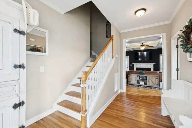 a view of a hallway view with wooden floor and staircase