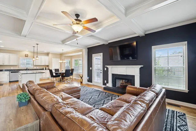 a living room with furniture fireplace and a flat screen tv