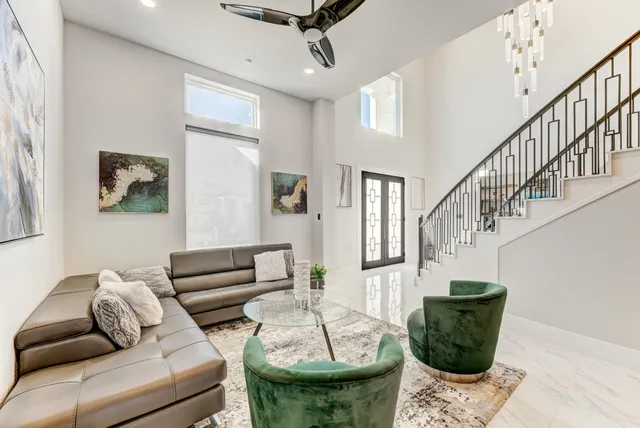 a living room with furniture and a potted plant