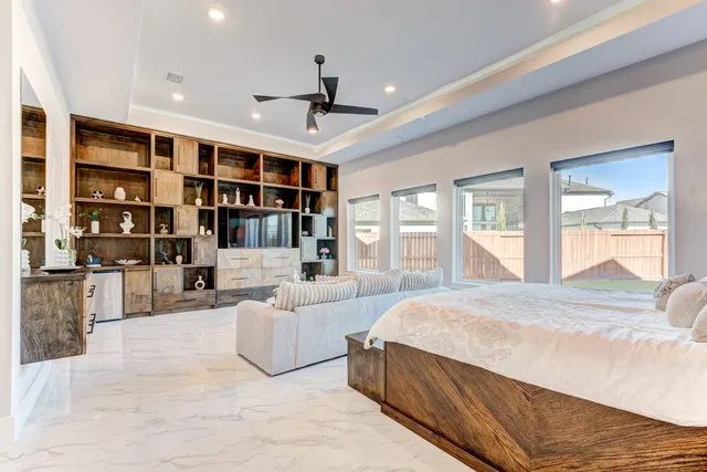 a spacious bedroom with a large bed and a large window