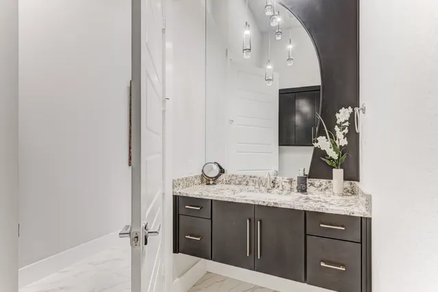 a bathroom with a sink vanity and mirror