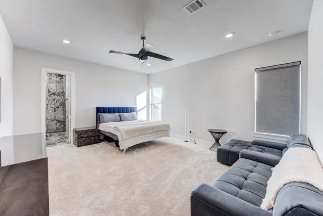 a bedroom with furniture and a ceiling fan