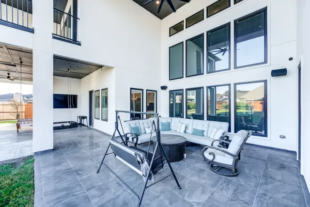 a building outdoor space with patio furniture and potted plants