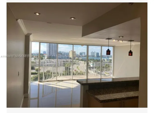 a kitchen view with granite countertop a stove and a large window