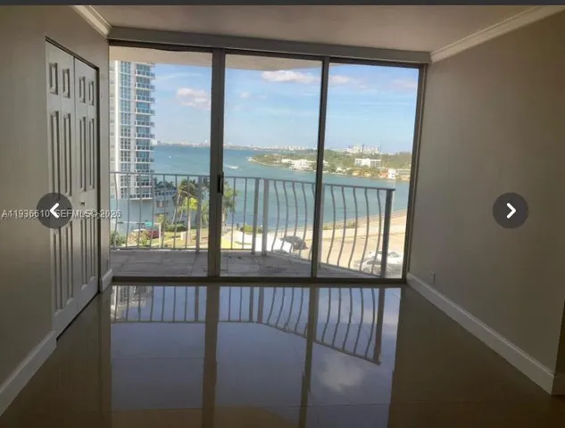 a view of a glass door with a balcony from a window