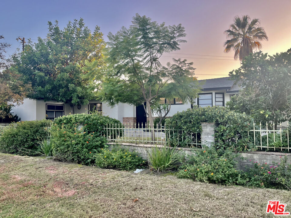 4675 Laurelgrove Avenue Studio City, CA 91604 - Photo 2 of 15 a front view of a house with a yard and potted plants