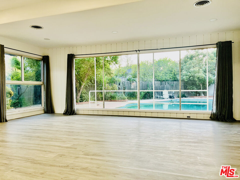 4675 Laurelgrove Avenue Studio City, CA 91604 - Photo 4 of 15 a view of a room with wooden floor and windows