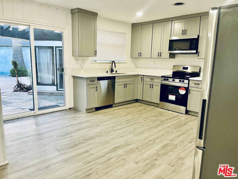 4675 Laurelgrove Avenue Studio City, CA 91604 - Photo 5 of 15 a kitchen with stainless steel appliances granite countertop a stove sink and cabinets