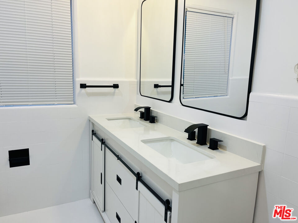 4675 Laurelgrove Avenue Studio City, CA 91604 - Photo 8 of 15 a bathroom with a sink and a mirror