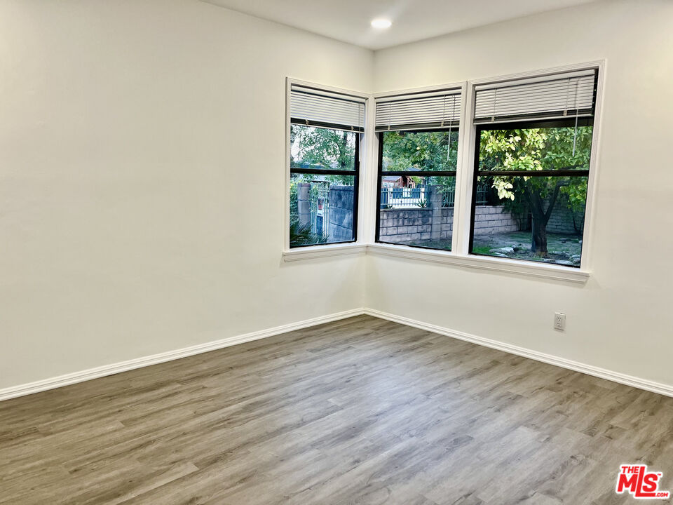 4675 Laurelgrove Avenue Studio City, CA 91604 - Photo 9 of 15 a view of an empty room with wooden floor and a window