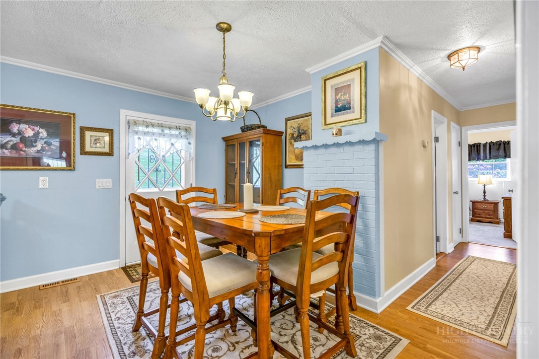 346 Piney Creek Road Lansing, NC 28643 - Photo 11 of 24 a view of a dining room with furniture and chandelier