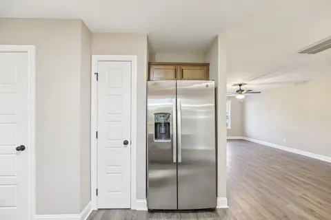 a metallic refrigerator freezer sitting in a kitchen