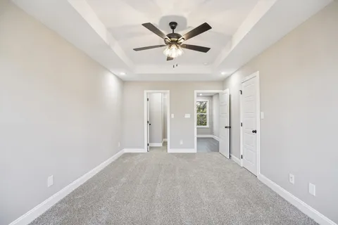 a view of an empty room with a ceiling fan