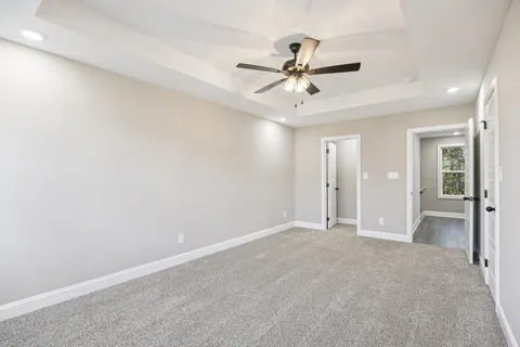 wooden floor in an empty room and a ceiling fan