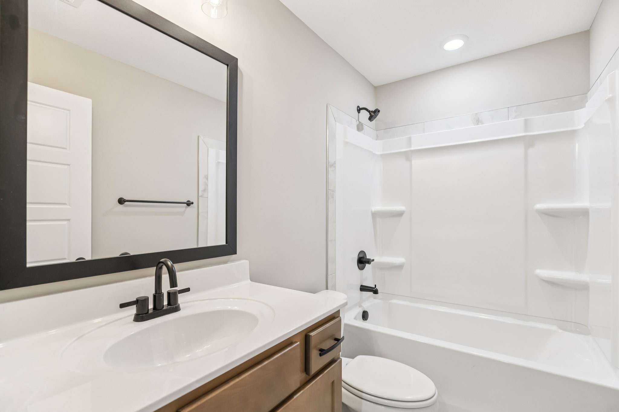 1288 Racker Drive Clarksville, TN 37043 - Photo 28 of 49 a bathroom with a bathtub shower sink vanity mirror and toilet