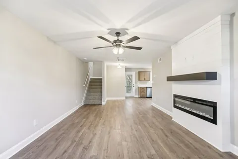 wooden floor in an empty room with a fireplace
