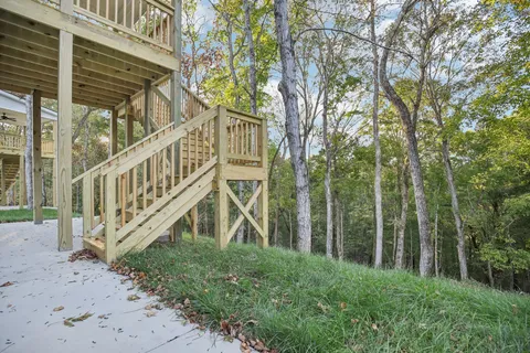 a view of a house with a yard from a deck