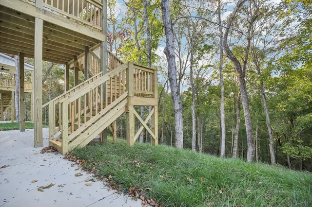 a view of a house with a yard from a deck
