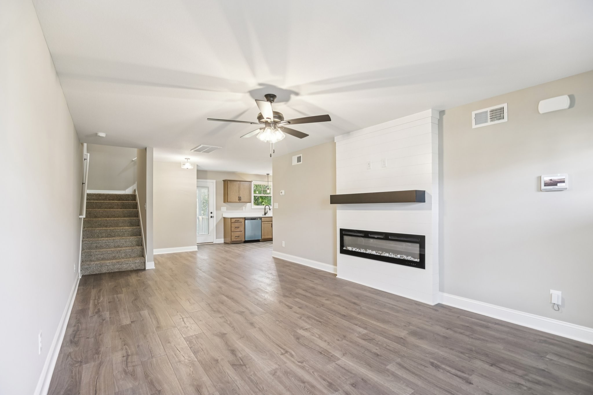 1288 Racker Drive Clarksville, TN 37043 - Photo 4 of 49 wooden floor in an empty room with a kitchen