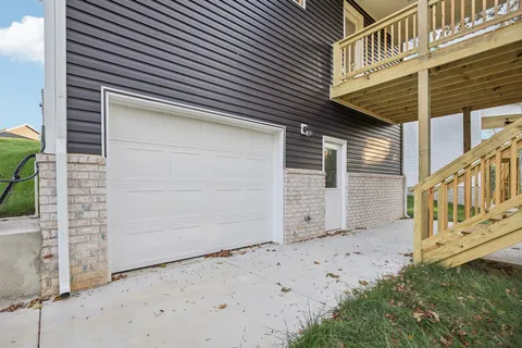 a view of a house with wooden fence