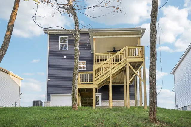 a view of a big house with a big yard and potted plants