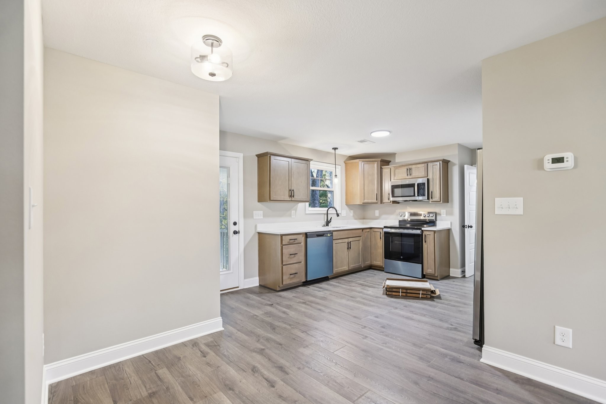 1288 Racker Drive Clarksville, TN 37043 - Photo 10 of 49 a large kitchen with a wooden floor and a large window