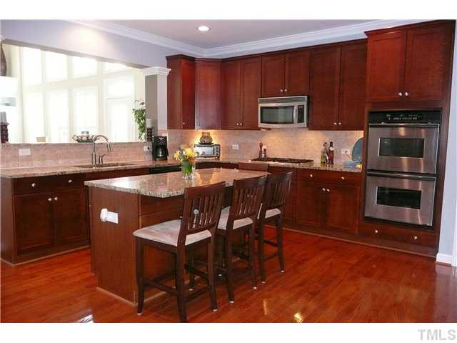 10504 Swerling Way Raleigh, NC 27614 - Photo 9 of 25 This gourmet kitchen is a cook's dream. The chef in the family will love the gas cooktop, double oven, large eat-at island, stainless appliances. granite countertops and tile backsplash. Kitchen