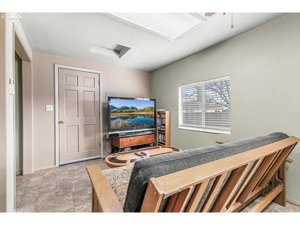 a bedroom with furniture and a flat screen tv