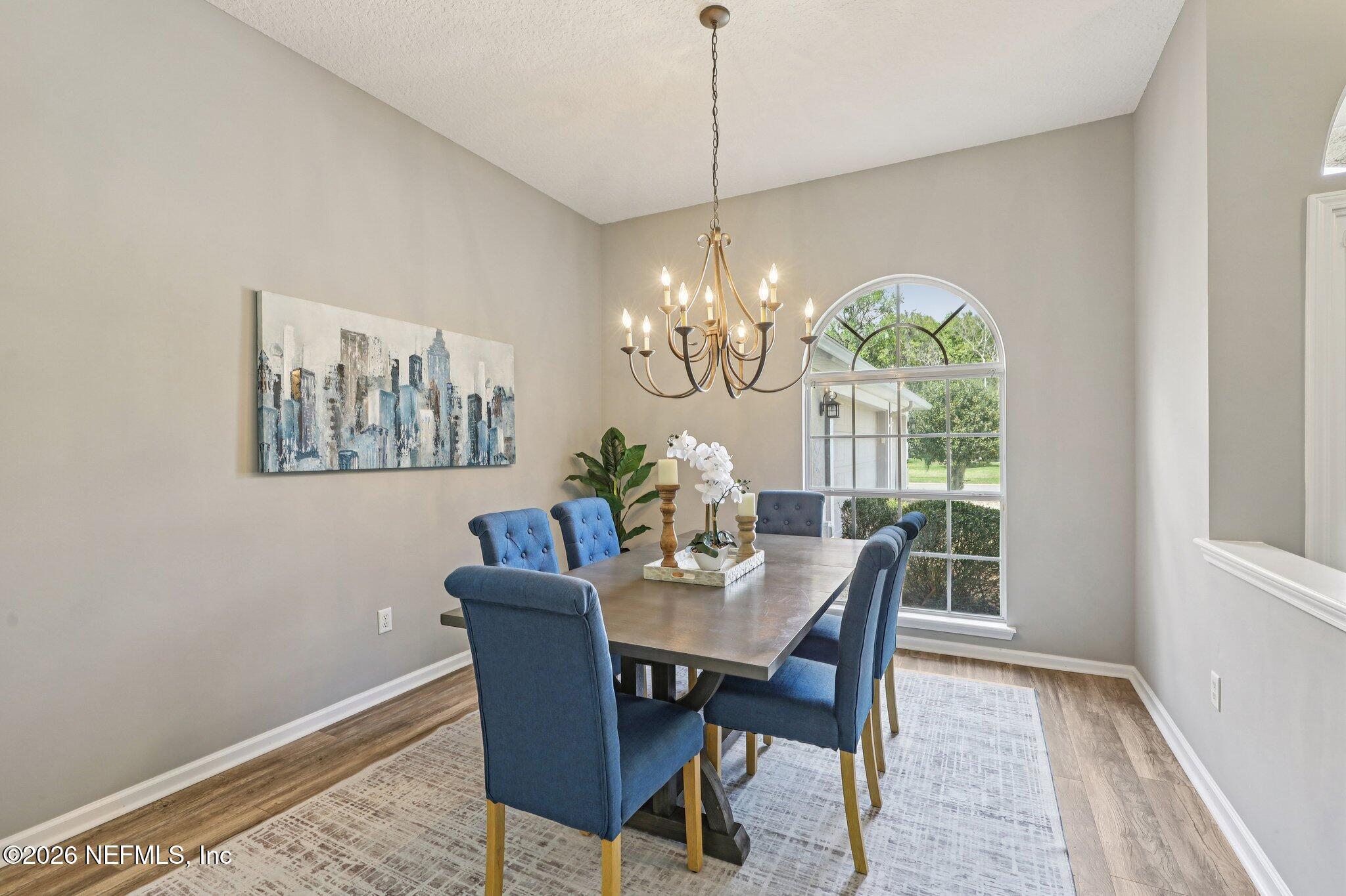 1933 Summit Ridge Road Fleming Island, FL 32003 - Photo 13 of 59 a dining room with furniture a rug and a chandelier