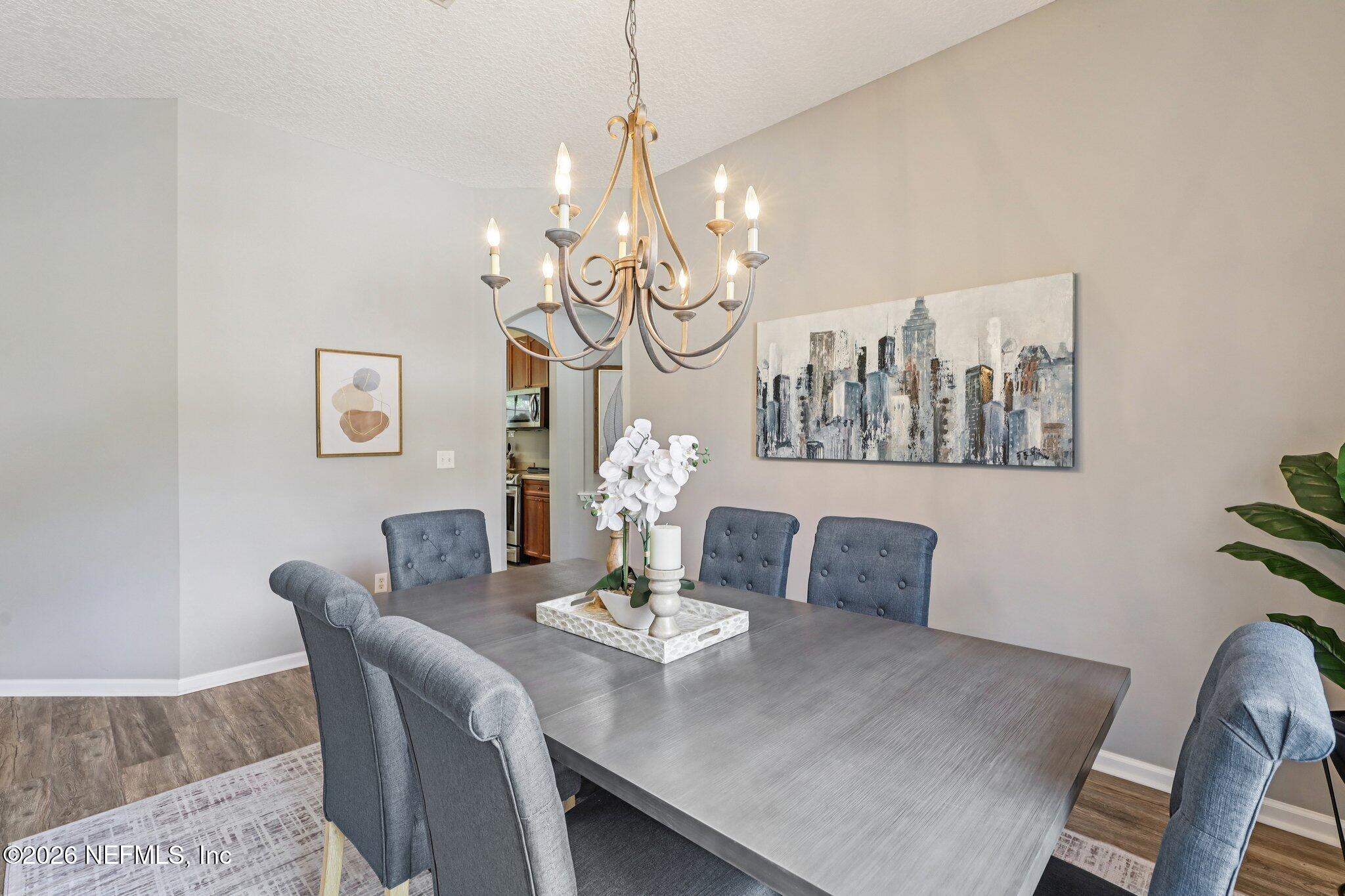 1933 Summit Ridge Road Fleming Island, FL 32003 - Photo 15 of 59 a view of a dining room with furniture and chandelier