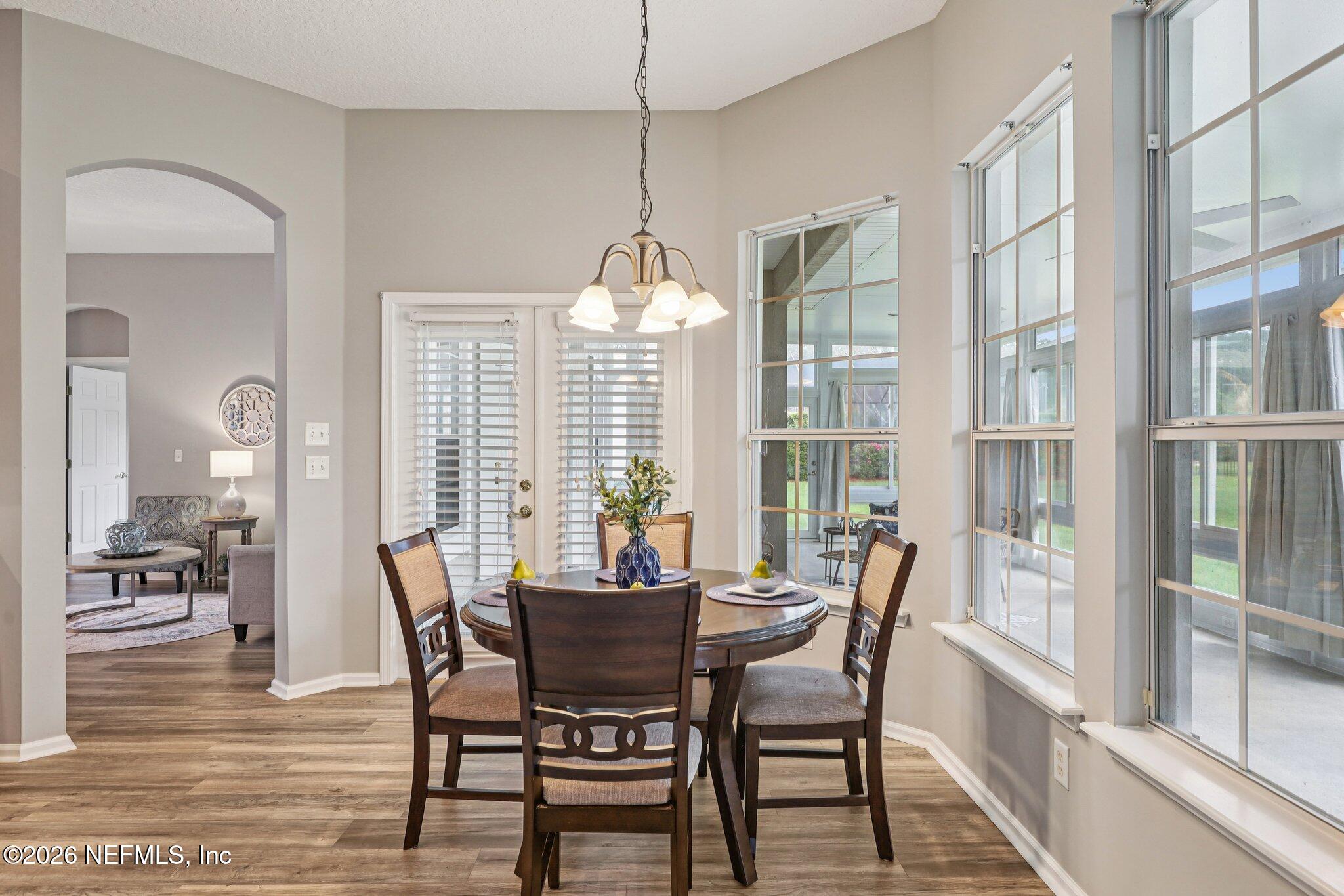 1933 Summit Ridge Road Fleming Island, FL 32003 - Photo 18 of 59 a view of a dining room with furniture large windows and wooden floor
