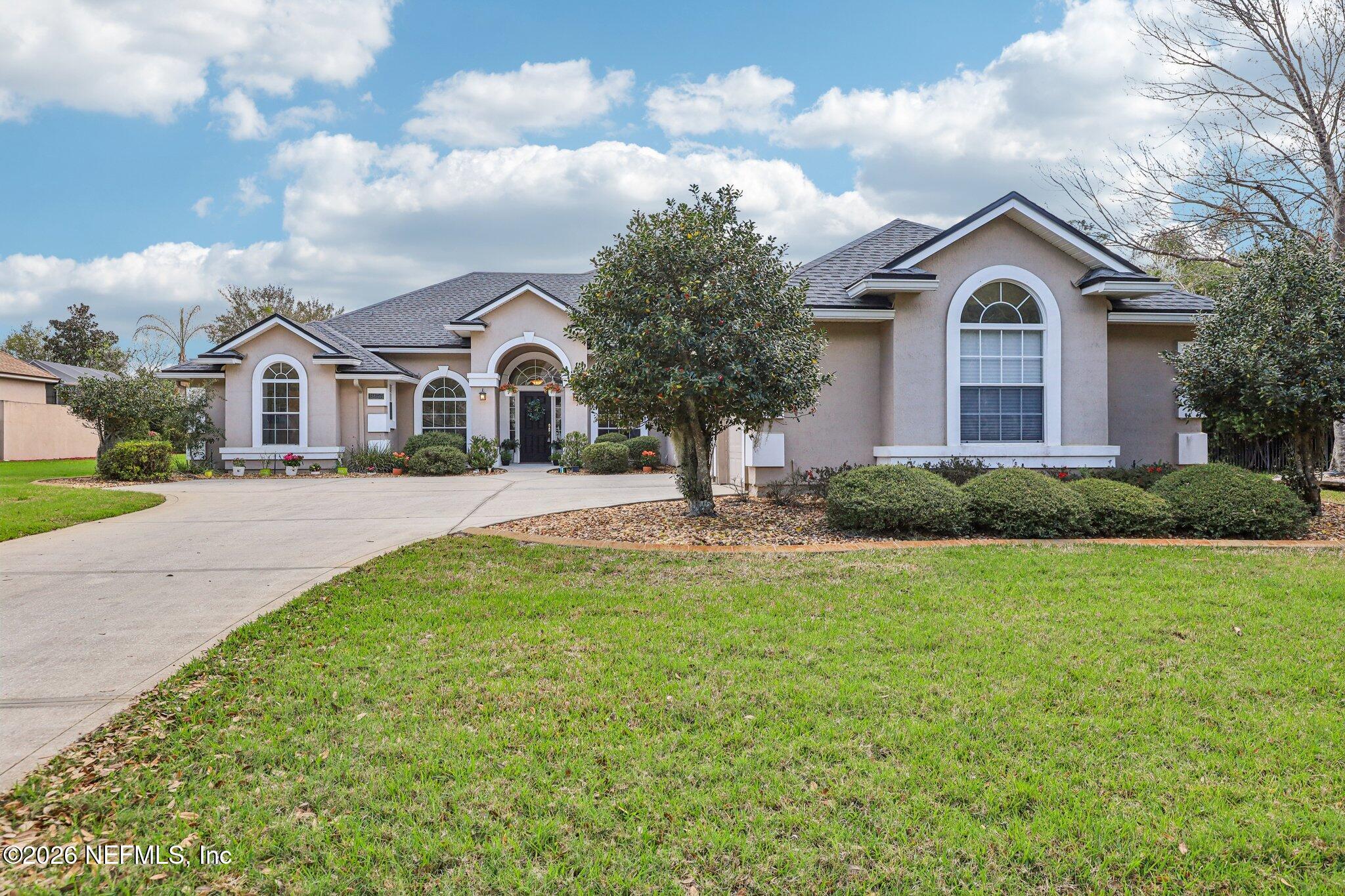 1933 Summit Ridge Road Fleming Island, FL 32003 - Photo 2 of 59 a front view of a house with garden