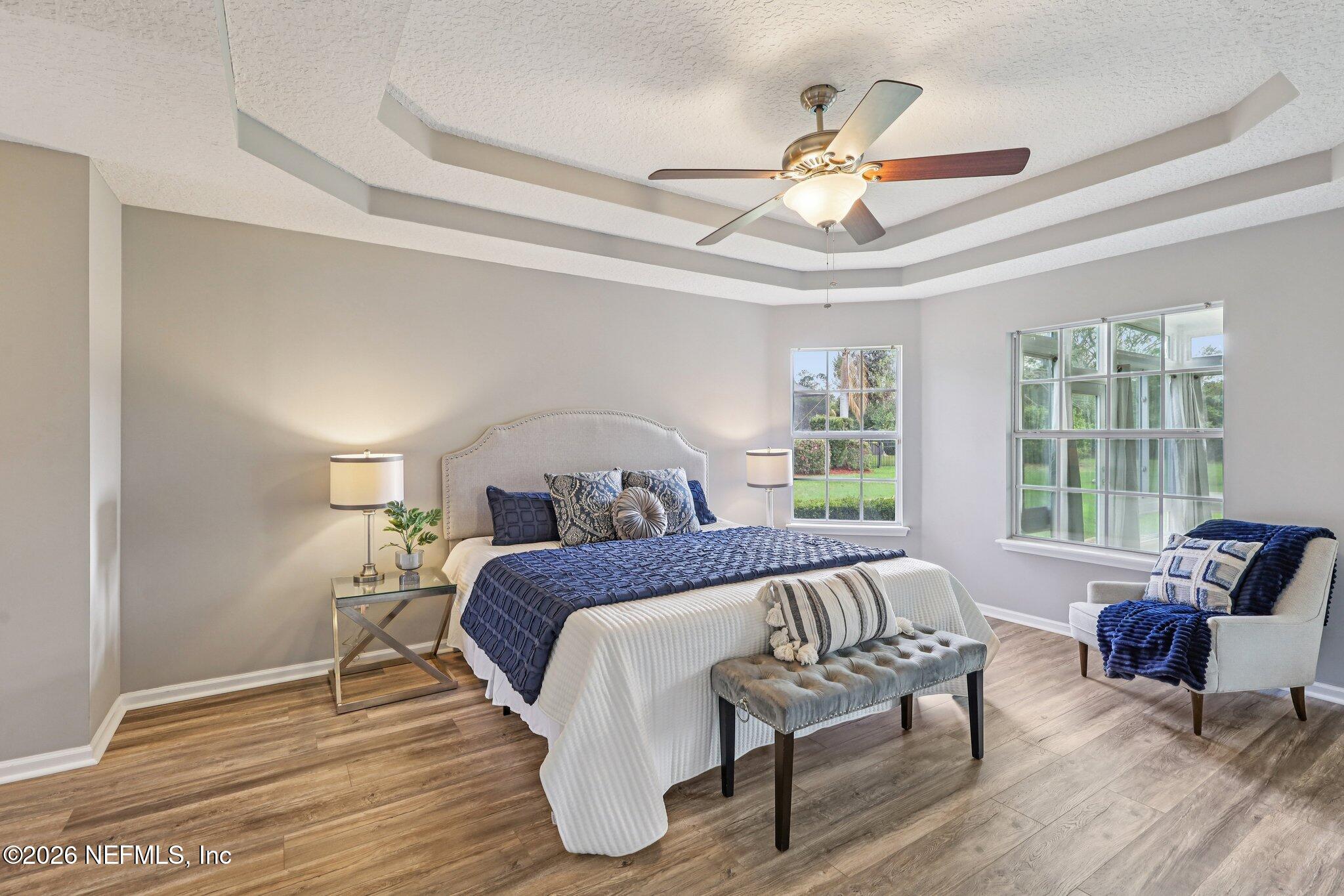 1933 Summit Ridge Road Fleming Island, FL 32003 - Photo 23 of 59 a spacious bedroom with a bed and a couch