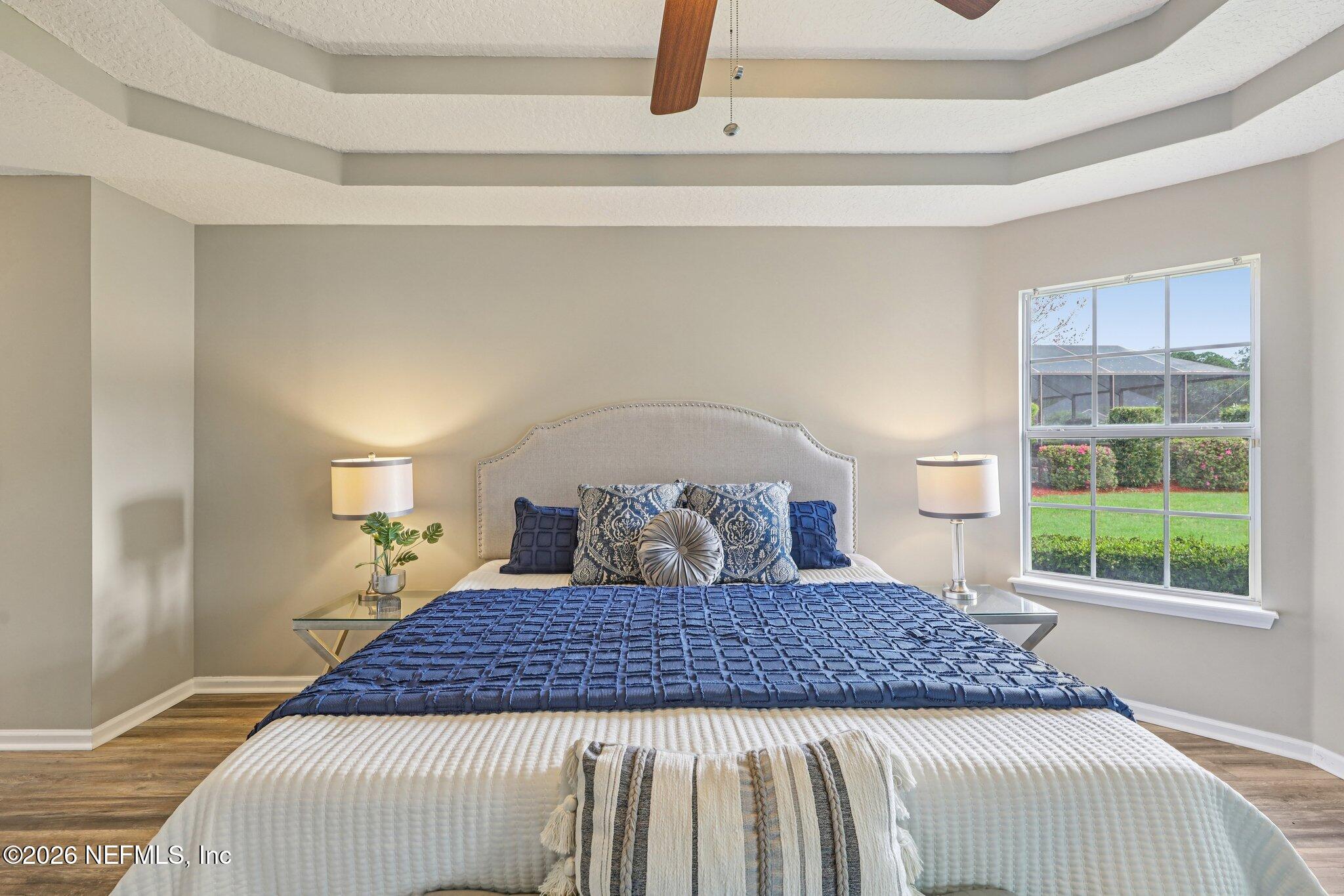 1933 Summit Ridge Road Fleming Island, FL 32003 - Photo 24 of 59 a large bed in a bedroom next to a window