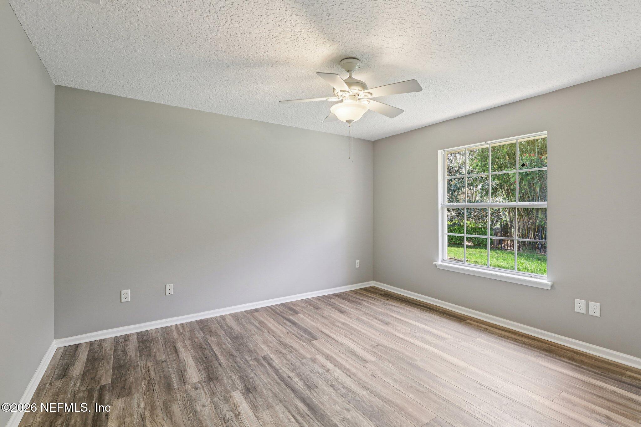 1933 Summit Ridge Road Fleming Island, FL 32003 - Photo 29 of 59 a view of an empty room with wooden floor and a window