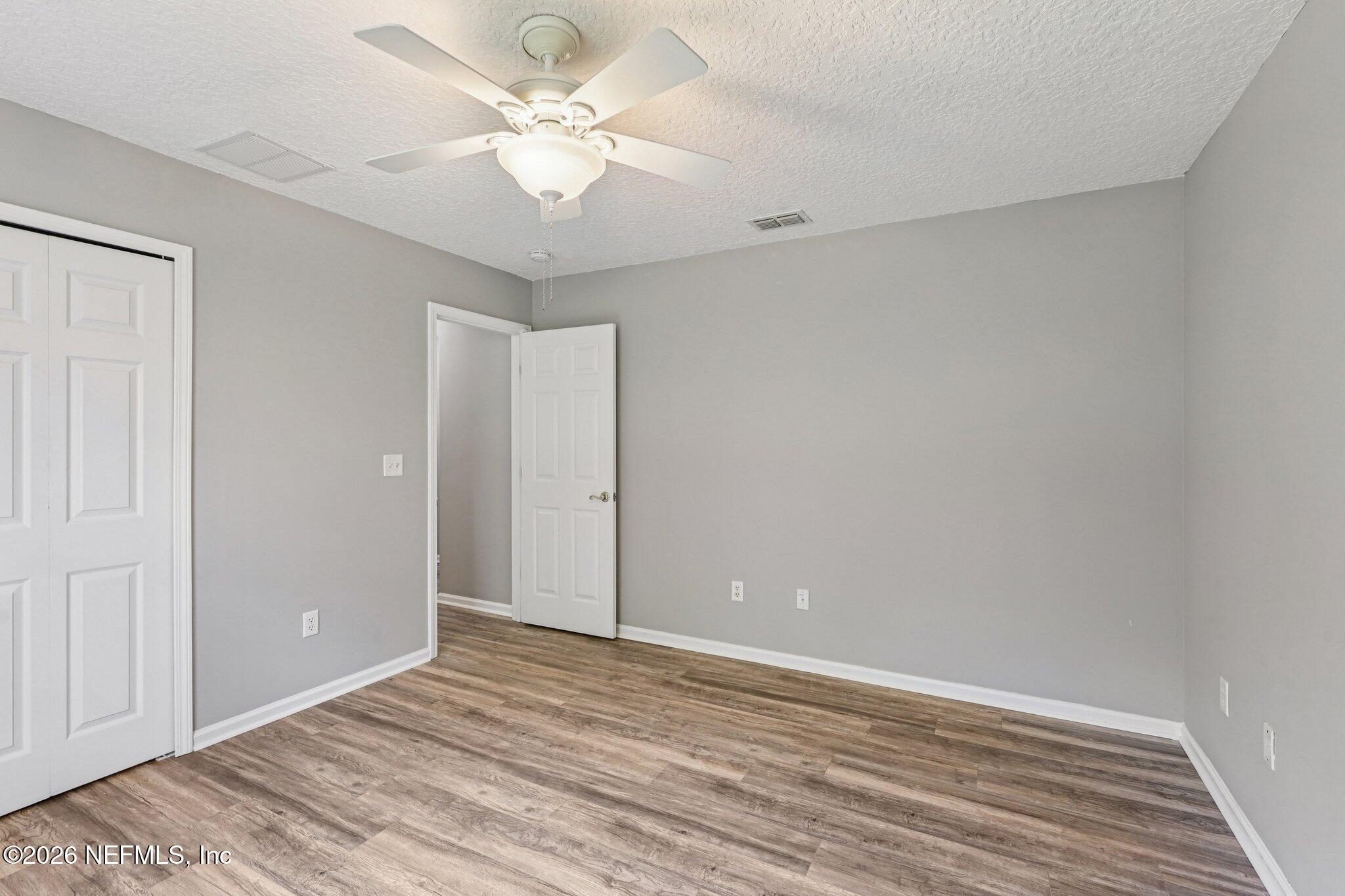 1933 Summit Ridge Road Fleming Island, FL 32003 - Photo 30 of 59 a view of an empty room with a ceiling fan