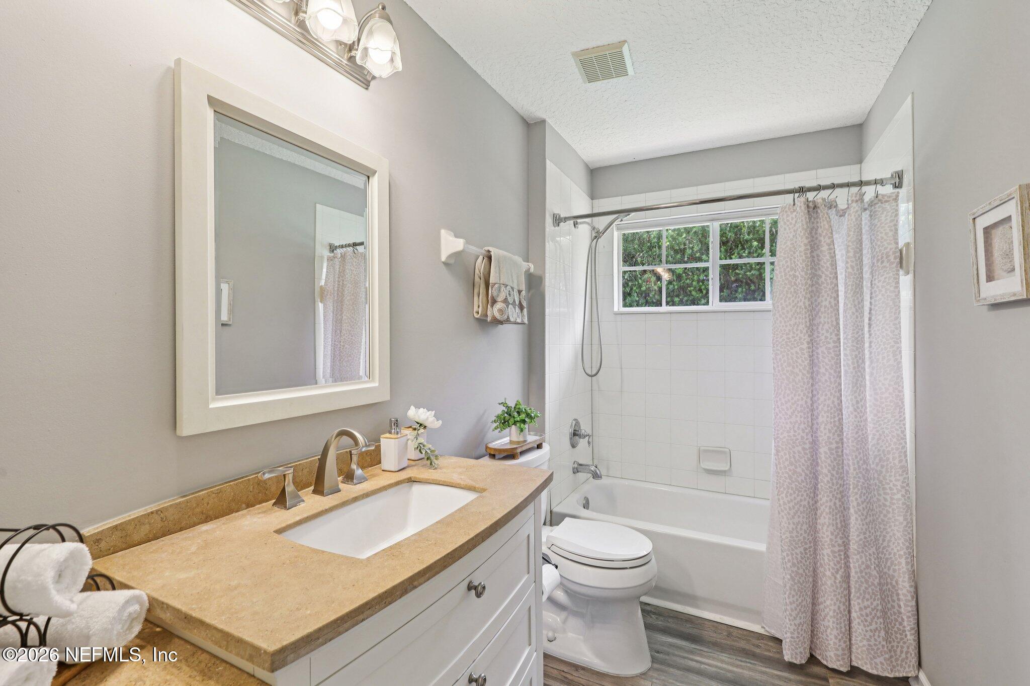 1933 Summit Ridge Road Fleming Island, FL 32003 - Photo 31 of 59 a bathroom with a granite countertop sink toilet and shower