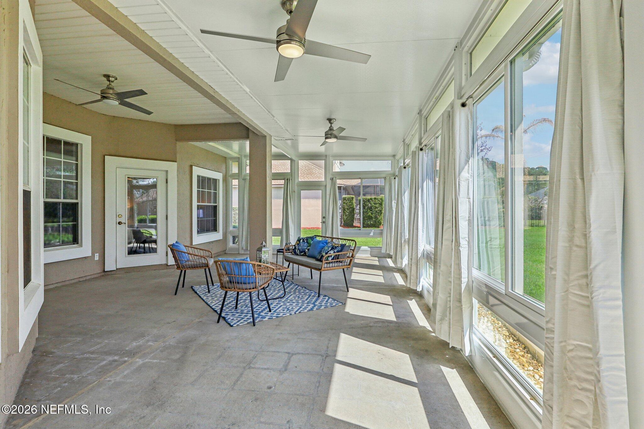 1933 Summit Ridge Road Fleming Island, FL 32003 - Photo 37 of 59 a living room with furniture and a floor to ceiling window