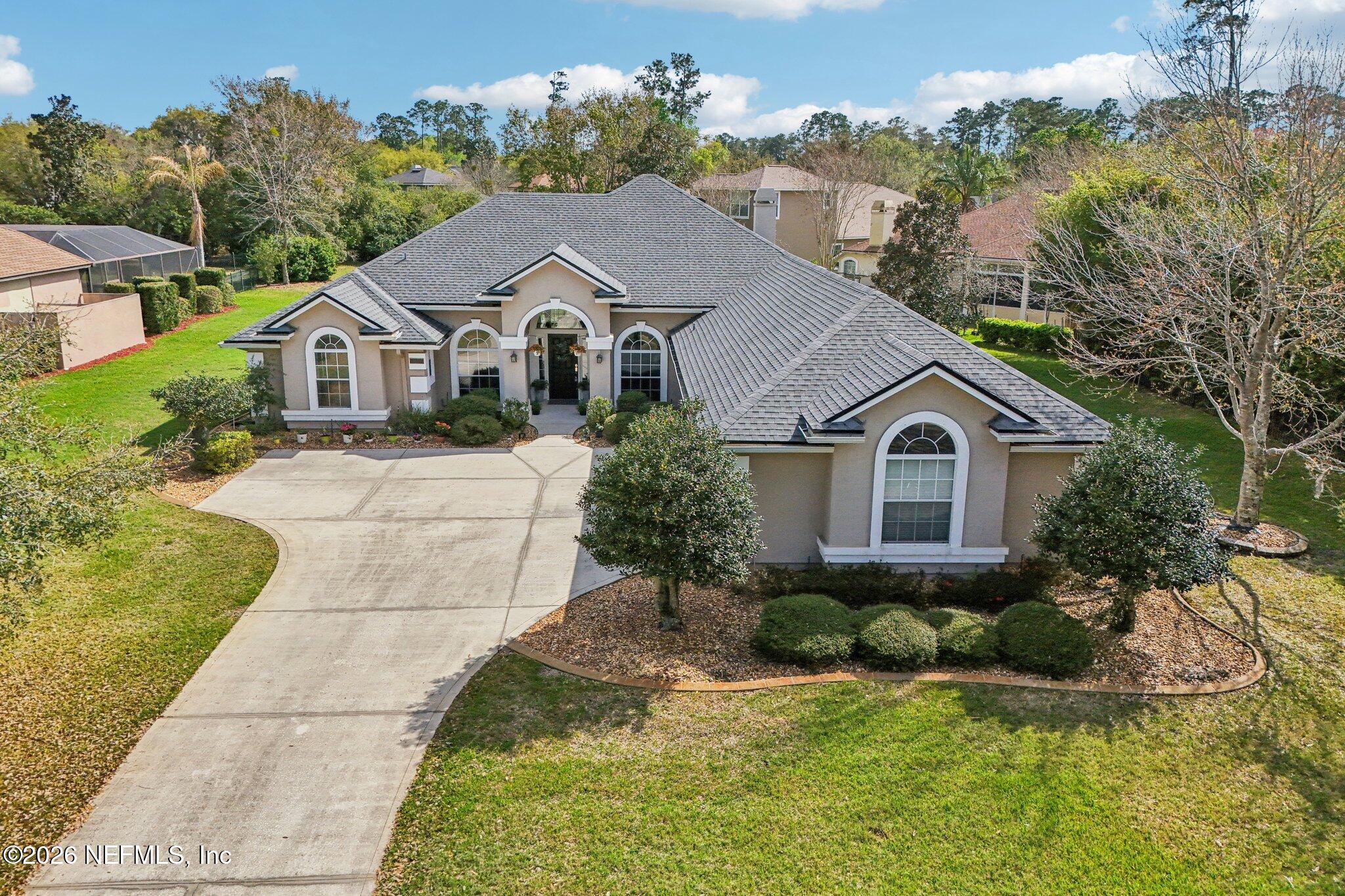 1933 Summit Ridge Road Fleming Island, FL 32003 - Photo 45 of 59 a front view of a house with a yard and garage