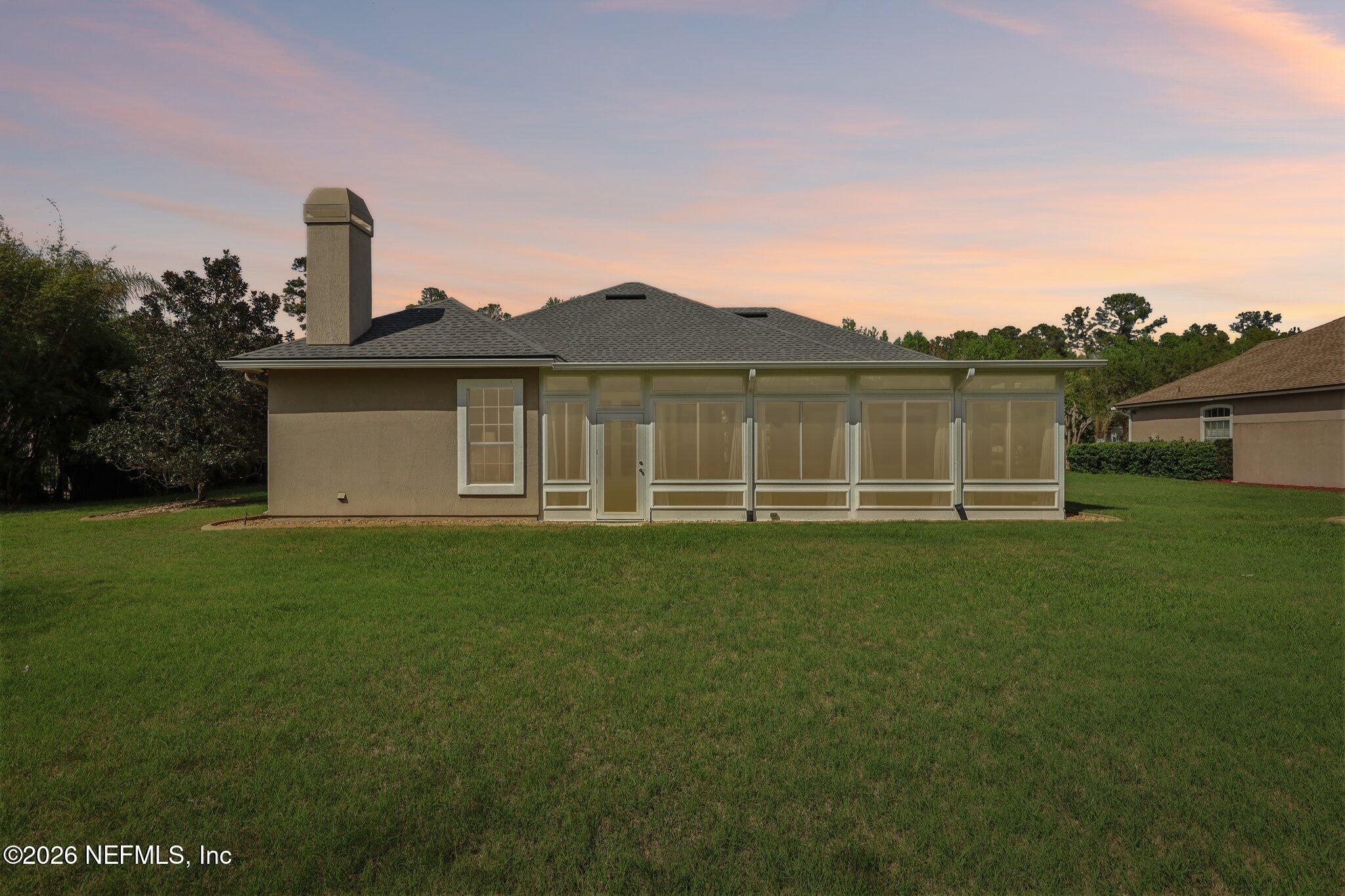 1933 Summit Ridge Road Fleming Island, FL 32003 - Photo 58 of 59 a front view of a house with a garden