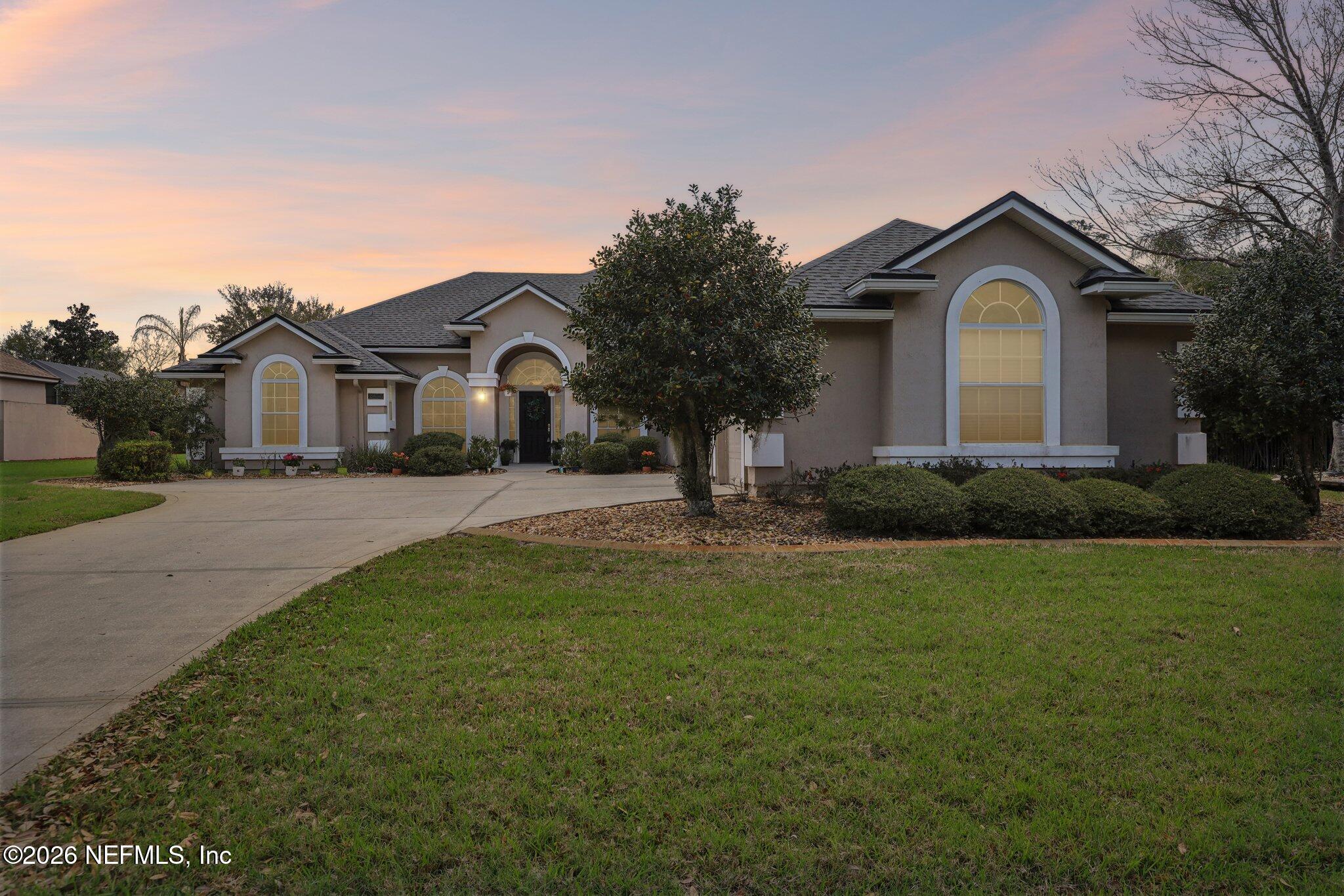 1933 Summit Ridge Road Fleming Island, FL 32003 - Photo 59 of 59 a front view of a house with a yard and garage