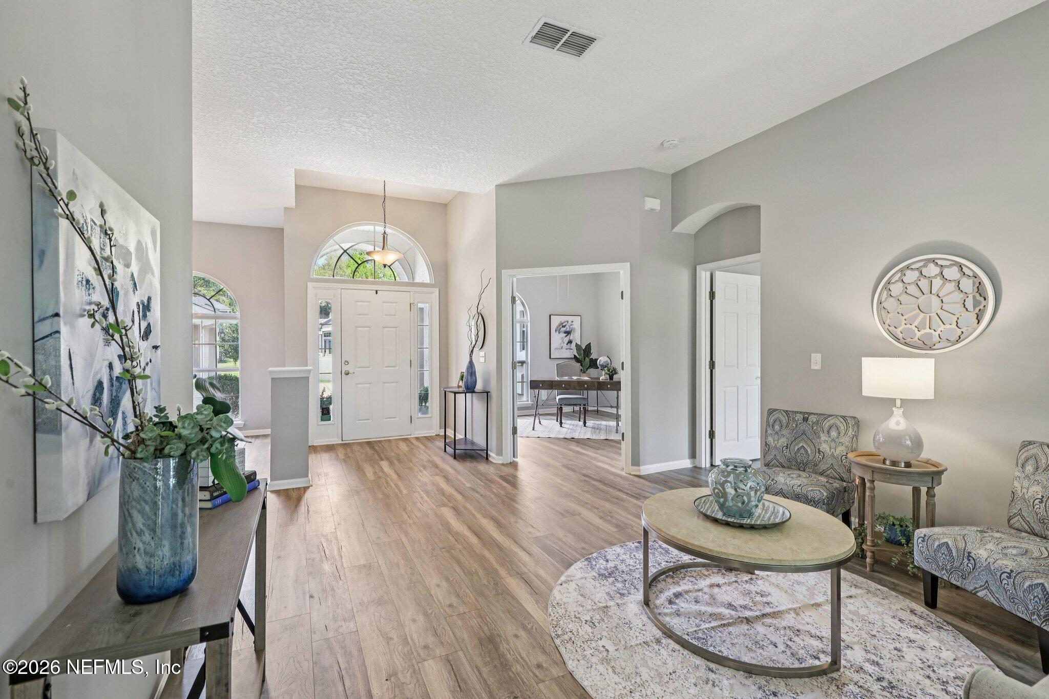 1933 Summit Ridge Road Fleming Island, FL 32003 - Photo 7 of 59 a living room with furniture and a table