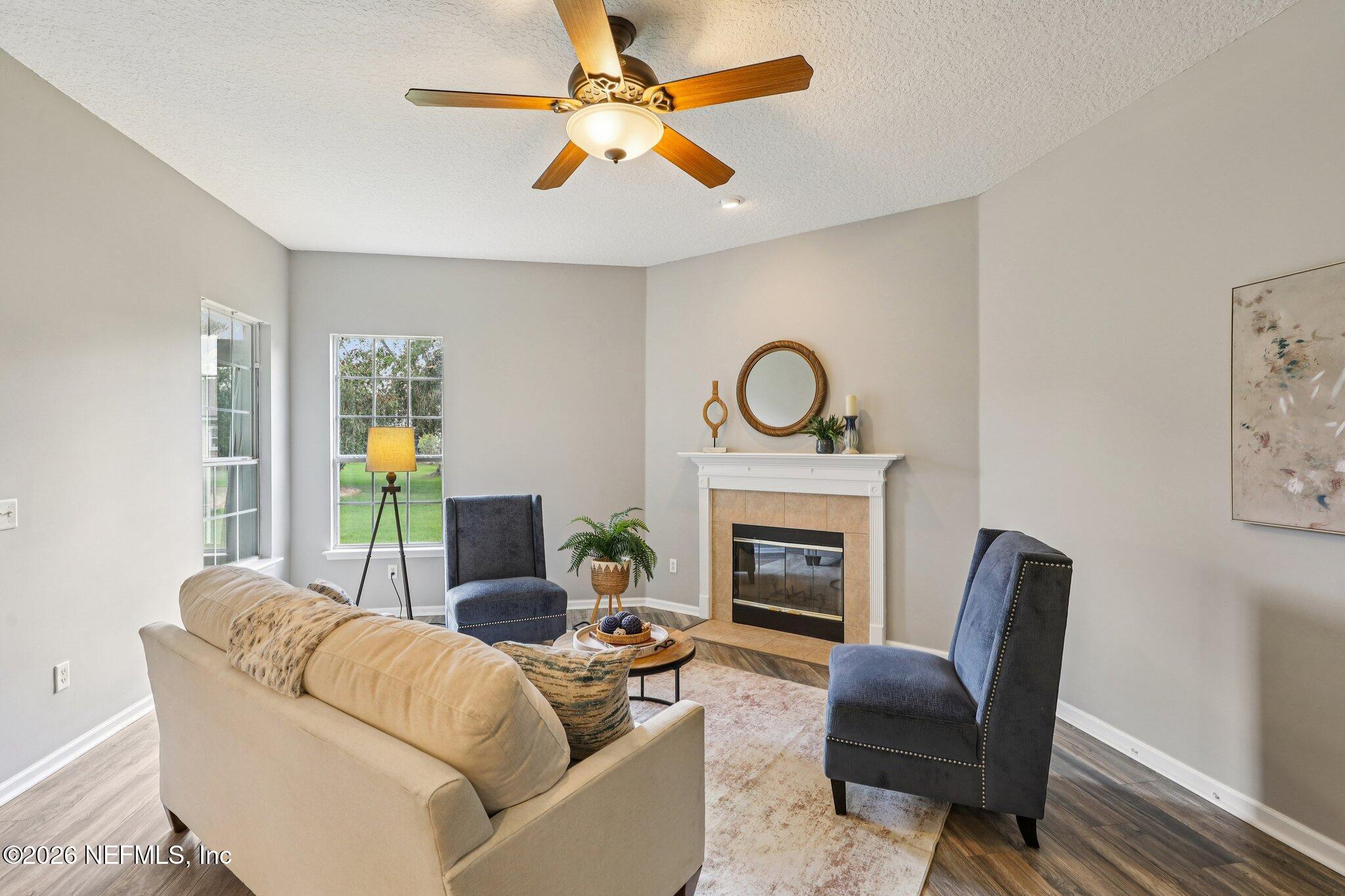 1933 Summit Ridge Road Fleming Island, FL 32003 - Photo 9 of 59 a living room with furniture a fireplace and a window