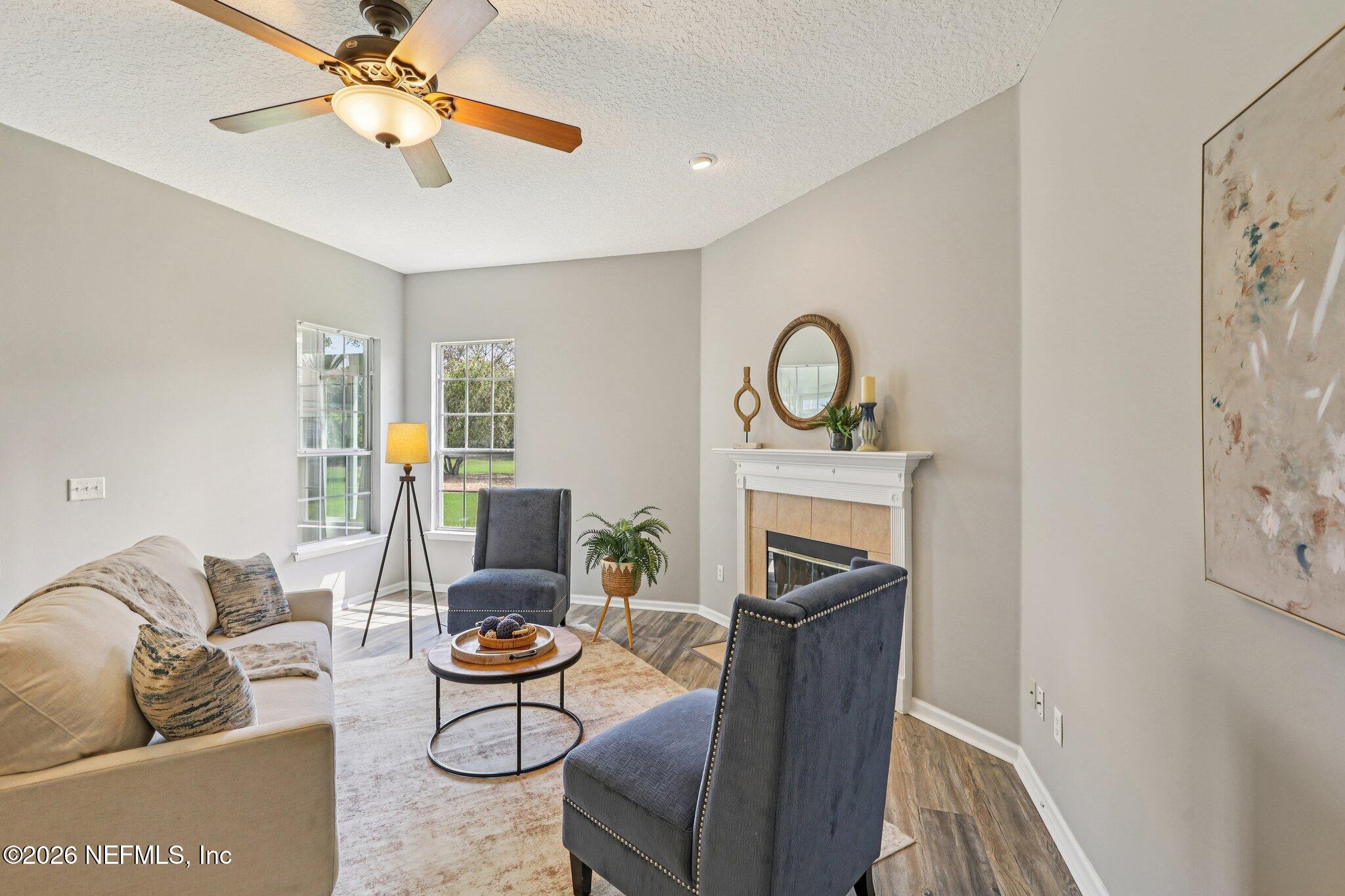 1933 Summit Ridge Road Fleming Island, FL 32003 - Photo 10 of 59 a living room with furniture and a fireplace