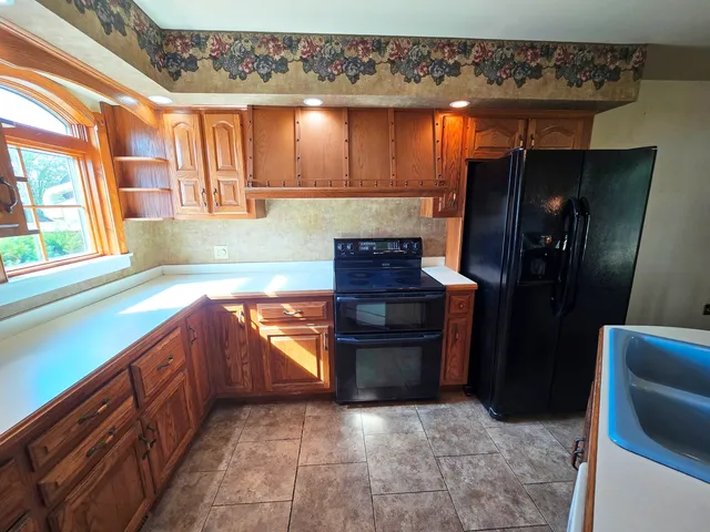 a dining room with furniture a rug and a chandelier