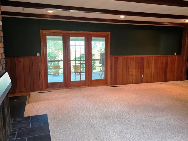a view of a hallway with closet and stairs