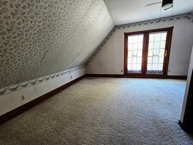 a view of an empty room with a fireplace