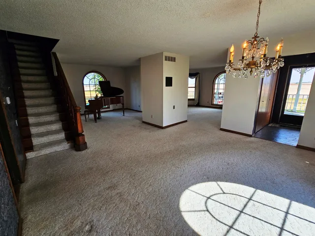 a view of a livingroom with furniture and chandelier