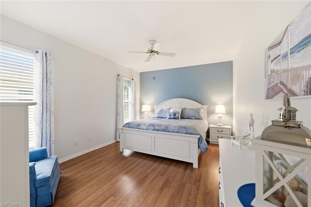157 Versailles Circle Naples, FL 34112 - Photo 16 of 36 a living room with furniture and a wooden floor
